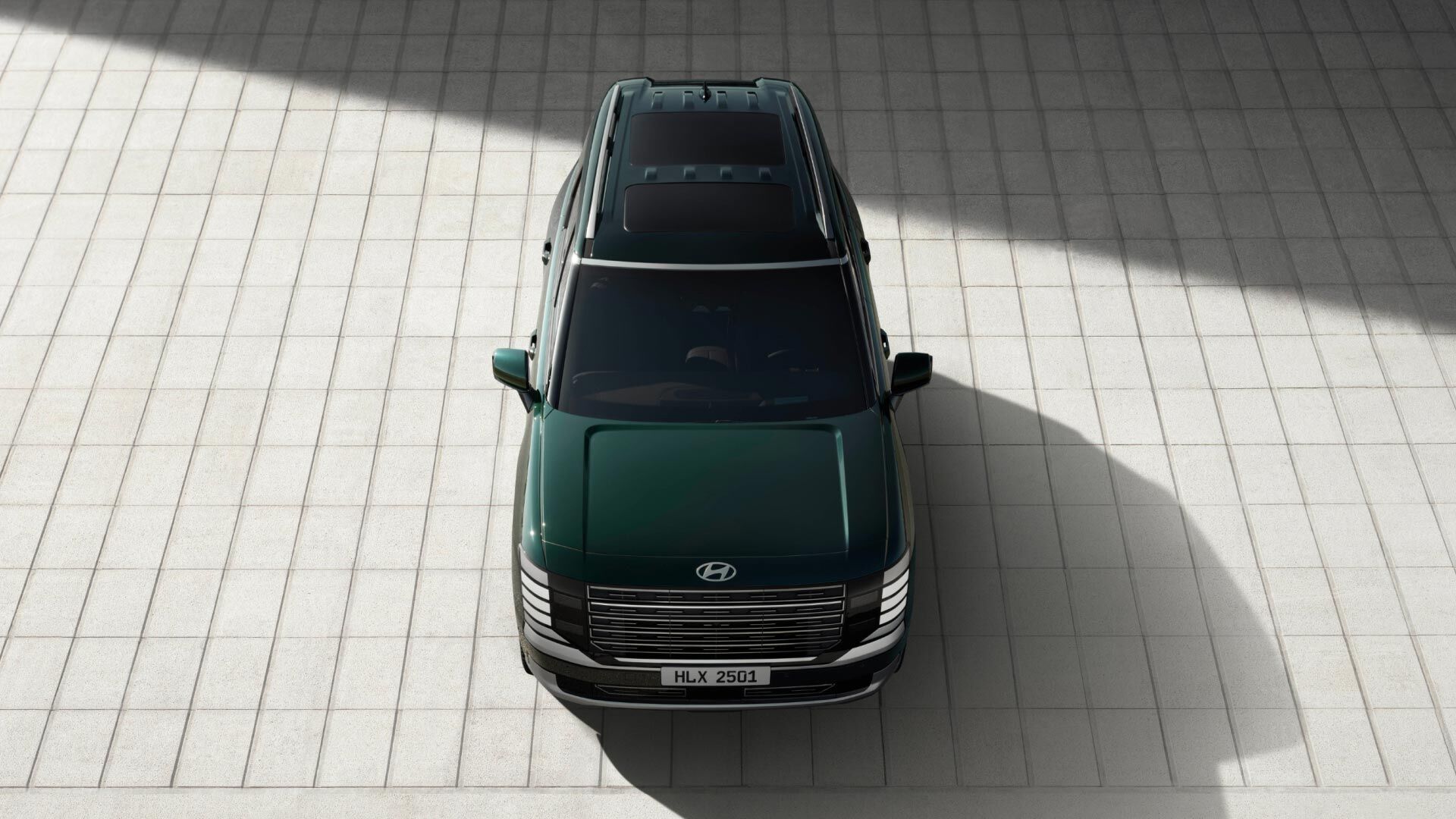 Side-front view of orange Grandi10 with lakeside view at night